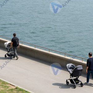 Люди с колясками гуляют по набережной