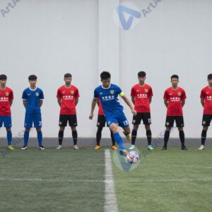 Футболисты стоят в стенке перед штрафным ударом.