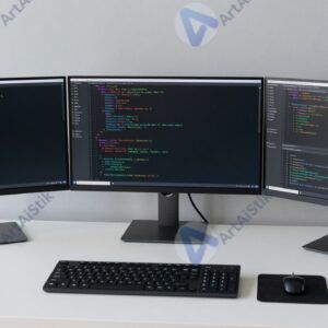 Стол программиста с тремя мониторами и тёмной темой кода.